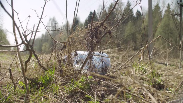 Trush bag lying in the forest. Social irresponsibility. Save the nature concept