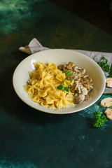 pasta farfalle with julienne mushrooms (fresh dish). food background. top