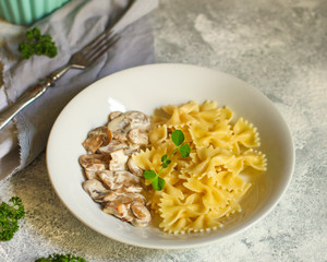 pasta farfalle with julienne mushrooms (fresh dish). food background. top