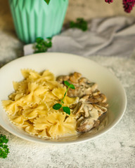 pasta farfalle with julienne mushrooms (fresh dish). food background. top