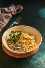 pasta farfalle with julienne mushrooms (fresh dish). food background. top