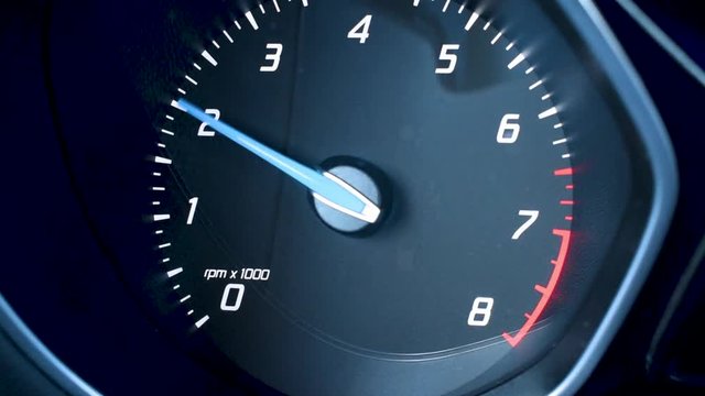 Tachometer needle movement on car dashboard