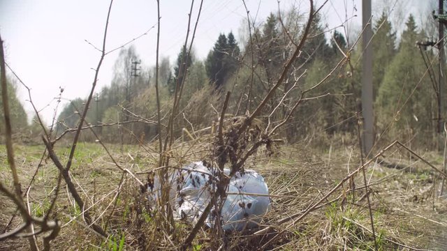 Trush bag lying in the woods. Social irresponsibility. Save the earth concept. Crane shot