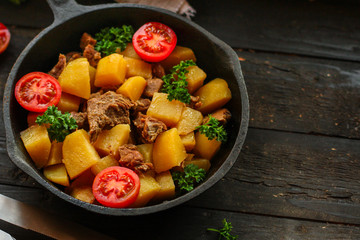 goulash, stewed potatoes with meat. stewed main course. food background. top