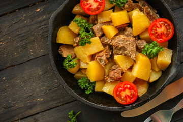 goulash, stewed potatoes with meat. stewed main course. food background. top