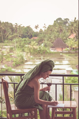 Happy Beautiful Woman sitting, relaxing and writing something into her diary. Relaxed time. Inspiration and fresh ideas concept