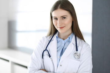 Doctor woman standing straight with arms crossed, portrait. Perfect medical service in clinic. Medicine and healthcare concepts