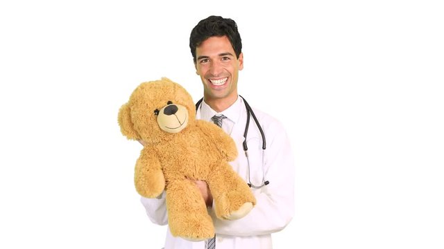 Doctor holding a teddy bear, pediatrician concept