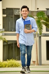 Smiling Handsome Asian Boy Student With Notebooks Walking