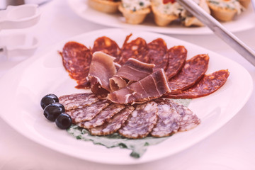 slices of salami and meat on the festival table