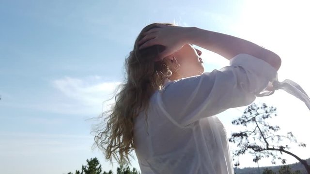 Beautiful happy girl woman playing with her blonde hair in sunset. 4K 