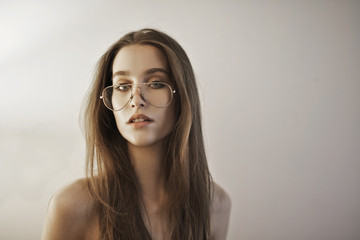 Portrait of a young beautiful woman wearing glasses.