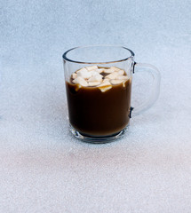 hot delicious coffee with sweet marshmallow air on silver background.