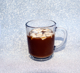 hot delicious coffee with sweet marshmallow air on silver background.