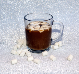 hot delicious coffee with sweet marshmallow air on silver background.