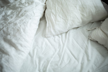 white linen pillows on bed