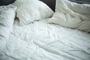 white linen pillows on bed