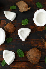 ripe coconut pieces on rustic wooden table