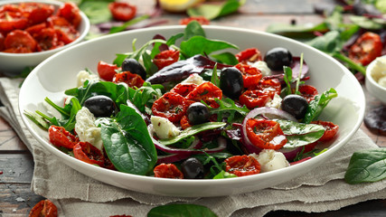 Sun dried tomatoes Salad with fresh vegetables mix and mozzarella cheese. healthy food