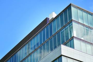 Fototapeta premium Modern office building with blue sky and clouds