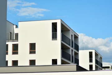 Apartment building with blue sky and clouds