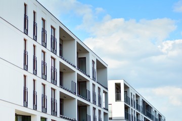 Obraz premium Apartment building with blue sky and clouds