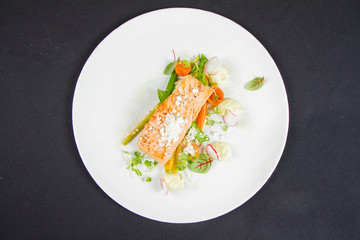 Grilled salmon with wasabi mashed potatoes, vegetables and lemon powder