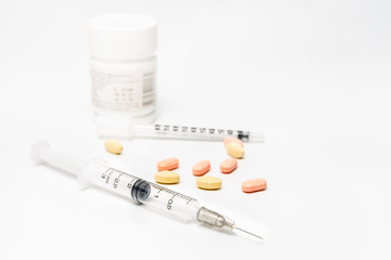 Drug syringe and medications on white background