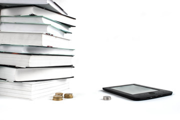 Reading books with E-book. Concept of cheap education. Stack of books and coins on white background