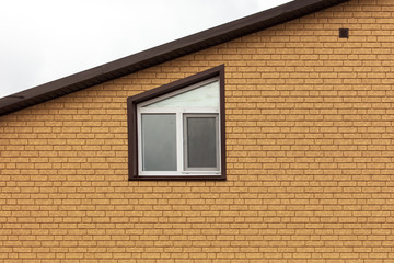 The window in the wall of the house of yellow brick