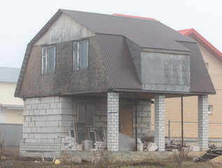 Cottage house in the fog