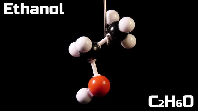 Ethanol C2H6O molecule rotating on black background