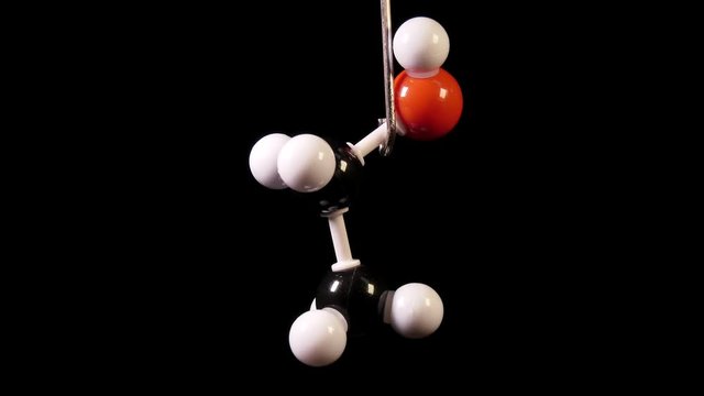 Ethanol C2H6O molecule rotating on black background