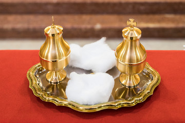 The oil of the catechumens and the chrism in their metal containers used during the Catholic...