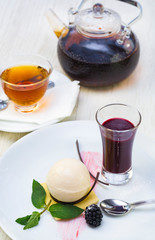 A piece of cake on a served table with tea