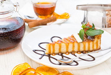 A piece of cake on a served table with tea
