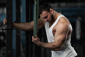 Fototapeta na wymiar Muscular Handsome Man Posing in Gym.