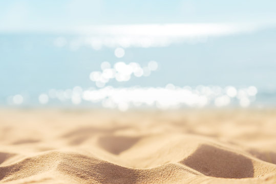 Summer tropical sand beach and bokeh sun light on sea background, copy space.