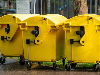 Image of Yellow waste Containers, Recycling bin for special Rubbish, during hail and rainy weather