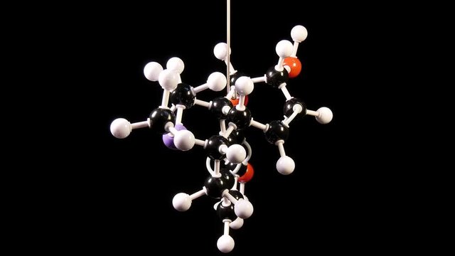 Morphine C17H19NO3 molecule isolated on black background rotating