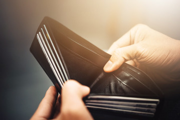 Empty wallet (no money) in the hands of an Businessman