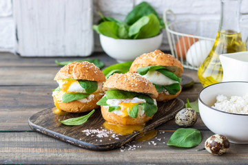 Veggie burger with poached egg and sorrel in a curd bun on rice flour