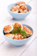 Meatballs in blue bowls on table.