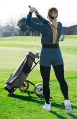 woman golfer propelled ball successfully at golf course