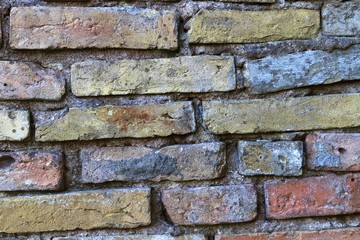 High resolution close up aged and weathered brick walls with red and yellow colored bricks
