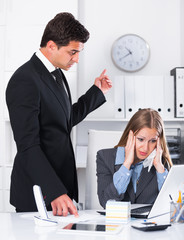 Dissatisfied manager scolding assistant