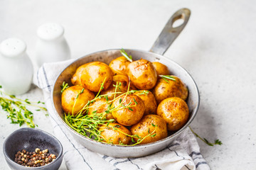 Baked potatoes in a cast iron skillet.