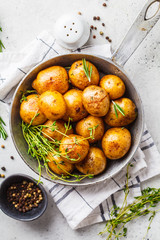 Baked potatoes in a cast iron skillet, top view.