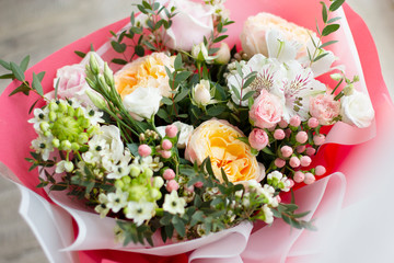 a large delicate bright bouquet of flowers of different sizes white, pink, orange colours, top view