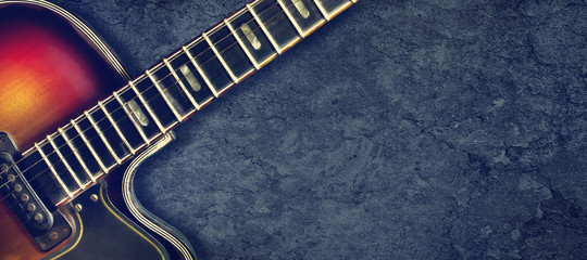Old jazz electro guitar on a dark background. Close up. Copy space. Background for music festivals,...